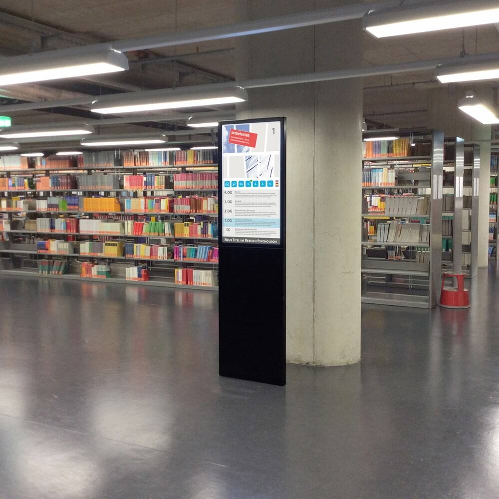 Brandschutz Digitale Info-Stele und Werbe-Stele Lena (FP Pro) ohne Bodenplatte in einer Universitätsbibliothek Freiburg.